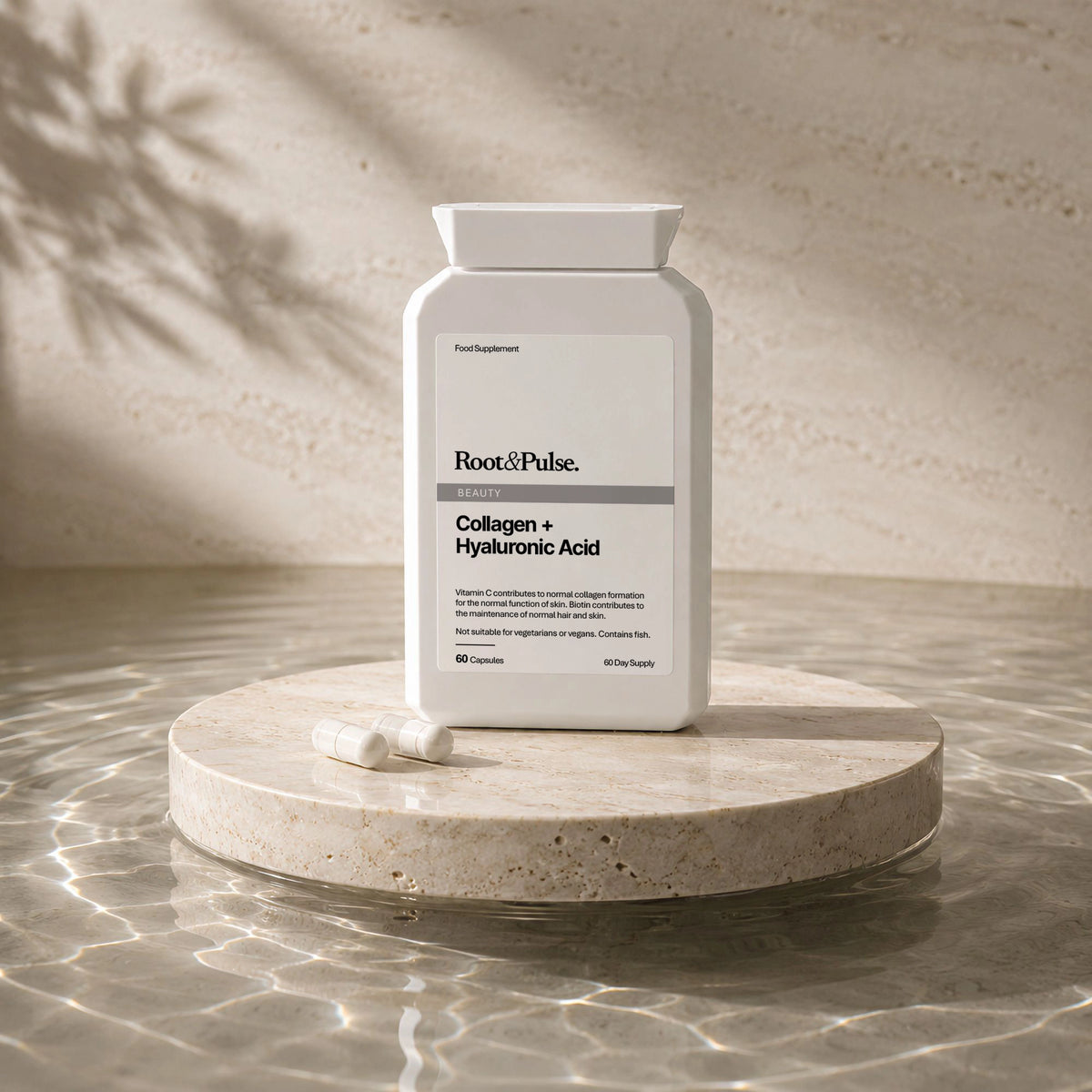 A white bottle of Root of Pulse Collagen + Hyaluronic Acid dietary supplement capsules sits on a round stone pedestal with two capsules placed in front, set against a textured beige stone background with soft leaf shadows.