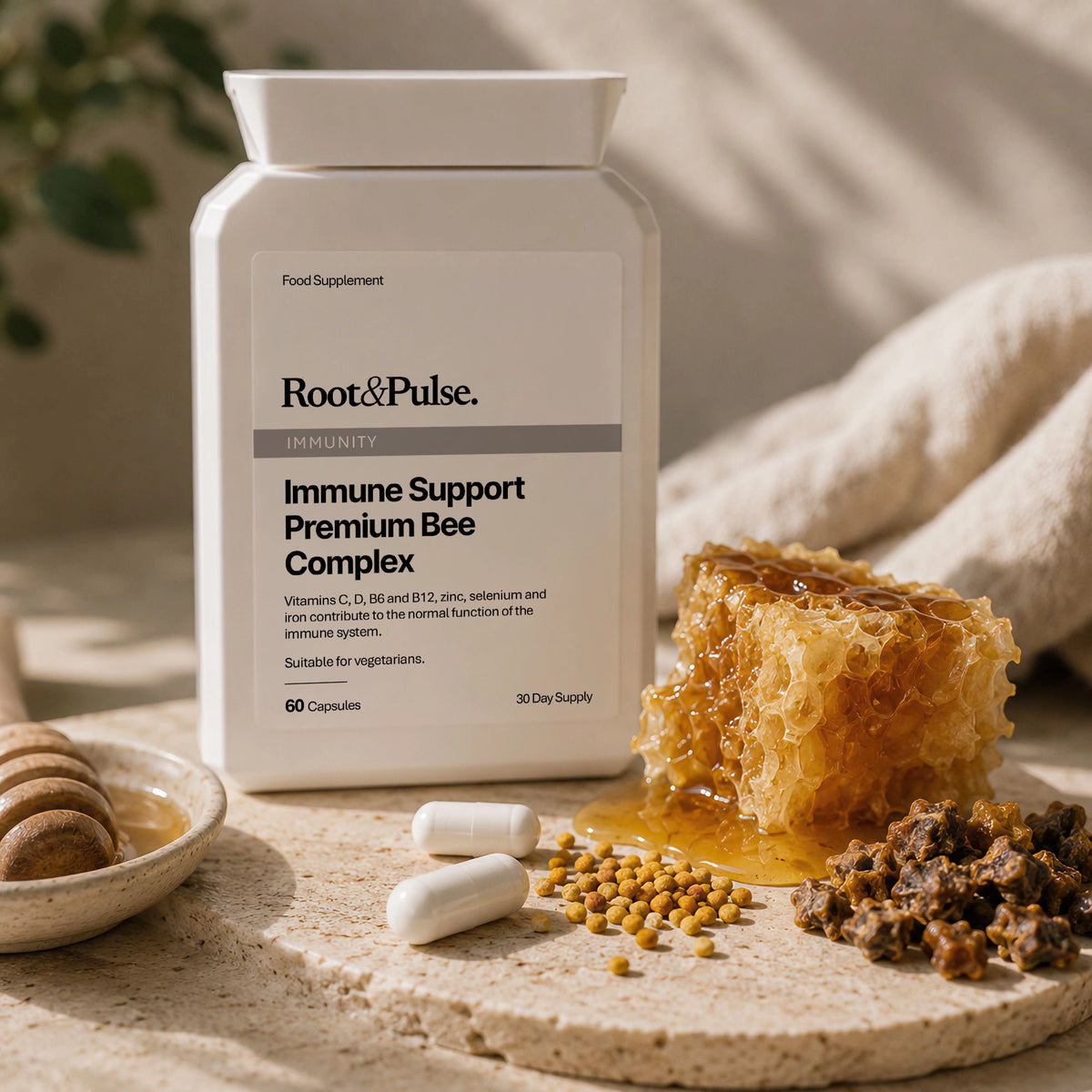 A white bottle of Root & Pulse Immunity Complex dietary supplement, styled on a stone surface with honeycomb, honey, capsules, and pollen.